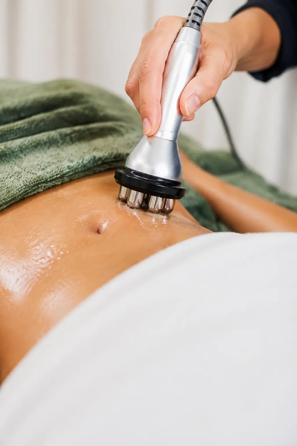 Handheld body-sculpting treatment on abdomen
